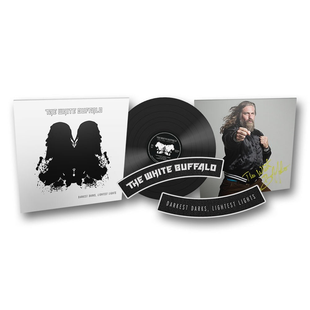 A signed black vinyl record of 'Darkest Darks, Lightest Lights' by The White Buffalo, representing the contrast between bold and subtle elements in art.
